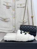 Chanel white fuzzy slip-on slides with black CC emblem, cushioned sole