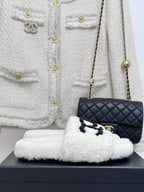 Chanel white fuzzy slip-on slides with black CC emblem, cushioned sole