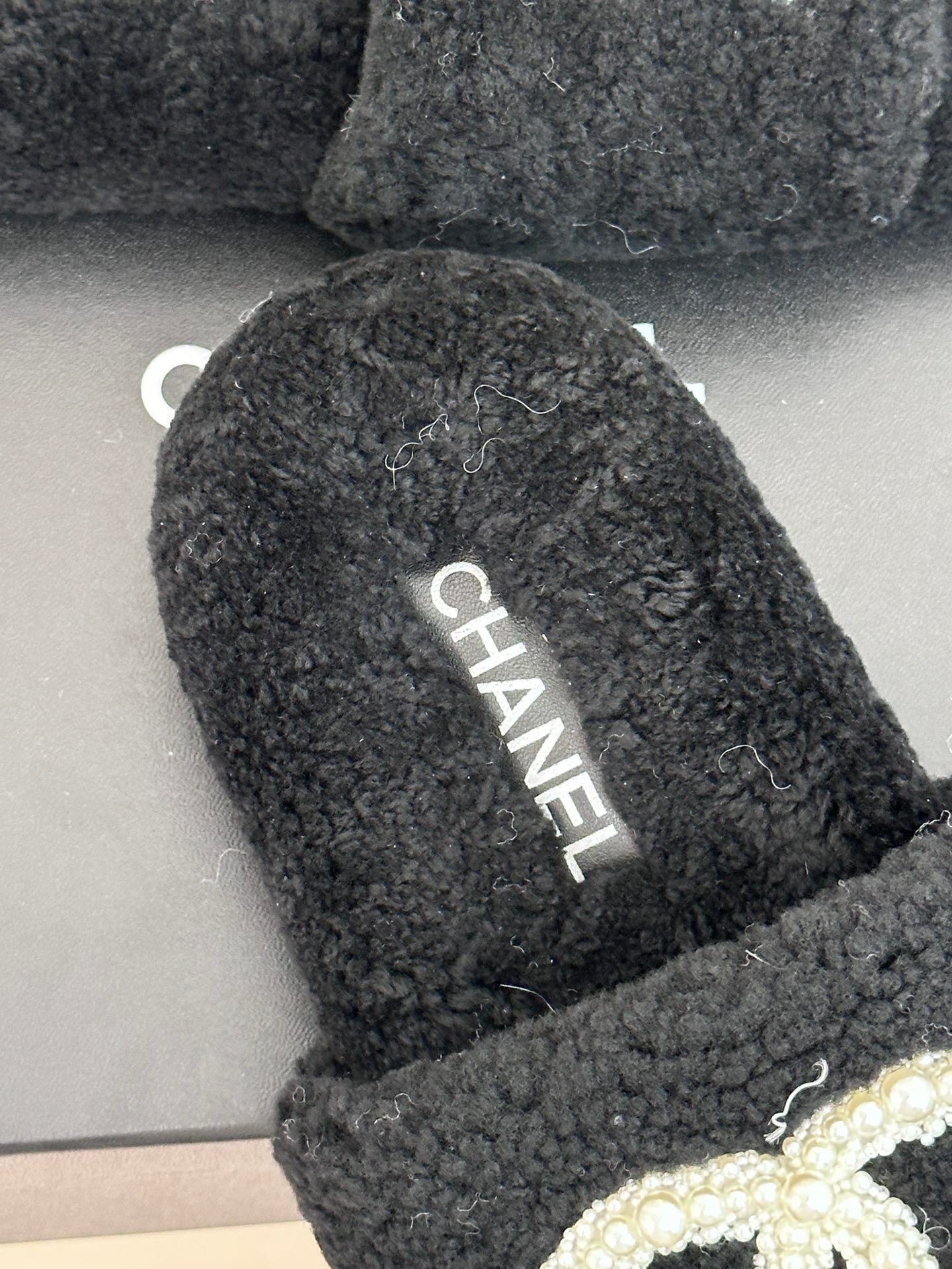 Women's dark navy CHANEL plush slides with CHANEL logo on footbed
