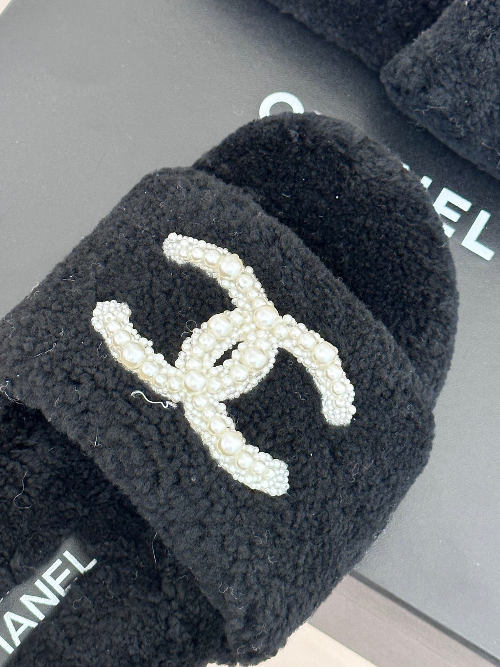 Women's dark navy CHANEL fuzzy slides with pearl-like CC logo detail