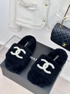 Women's dark navy CHANEL fuzzy slides with white CC logo strap