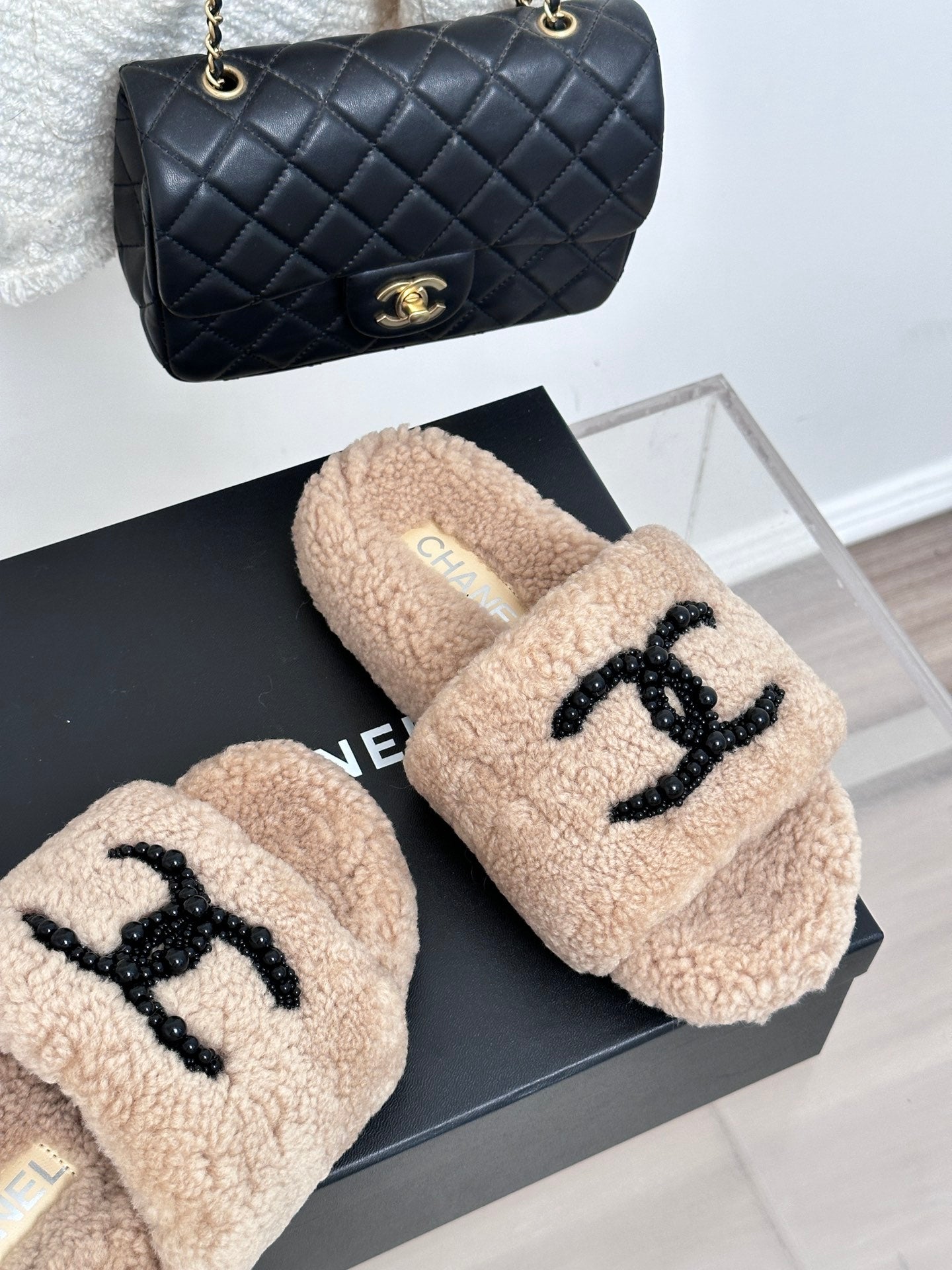 Beige sherpa slides with black beaded logo on strap, womens luxury shoes