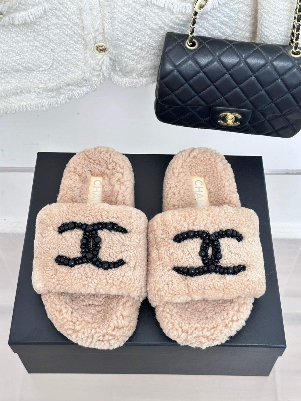 Beige sherpa slide slippers with black beaded logo straps, womens luxury shoes