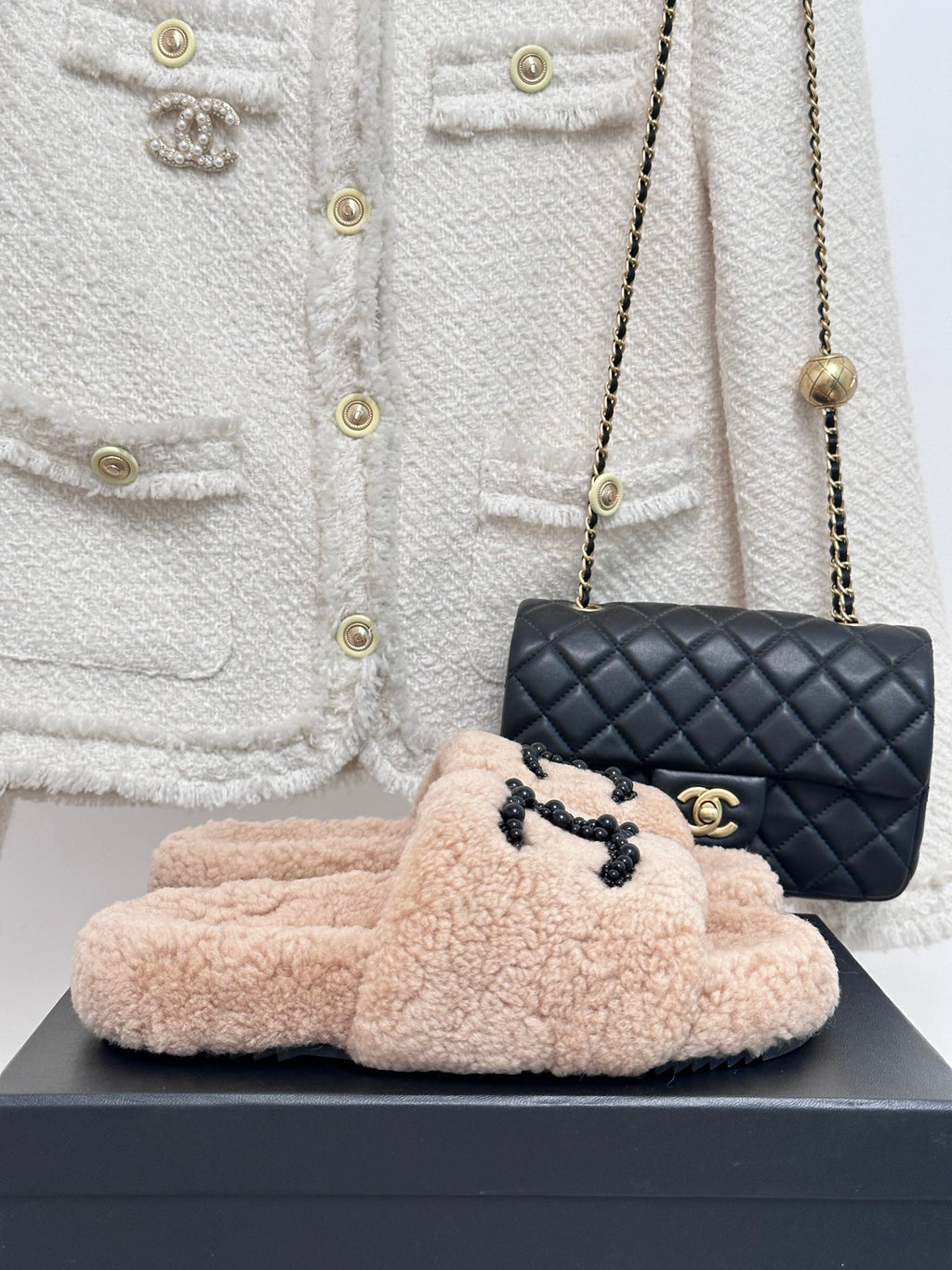 Beige plush shearling slides with black beaded logo strap, womens luxury shoes