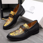 Versace loafer shoes in black with gold crest print and orange-brown buckle strap