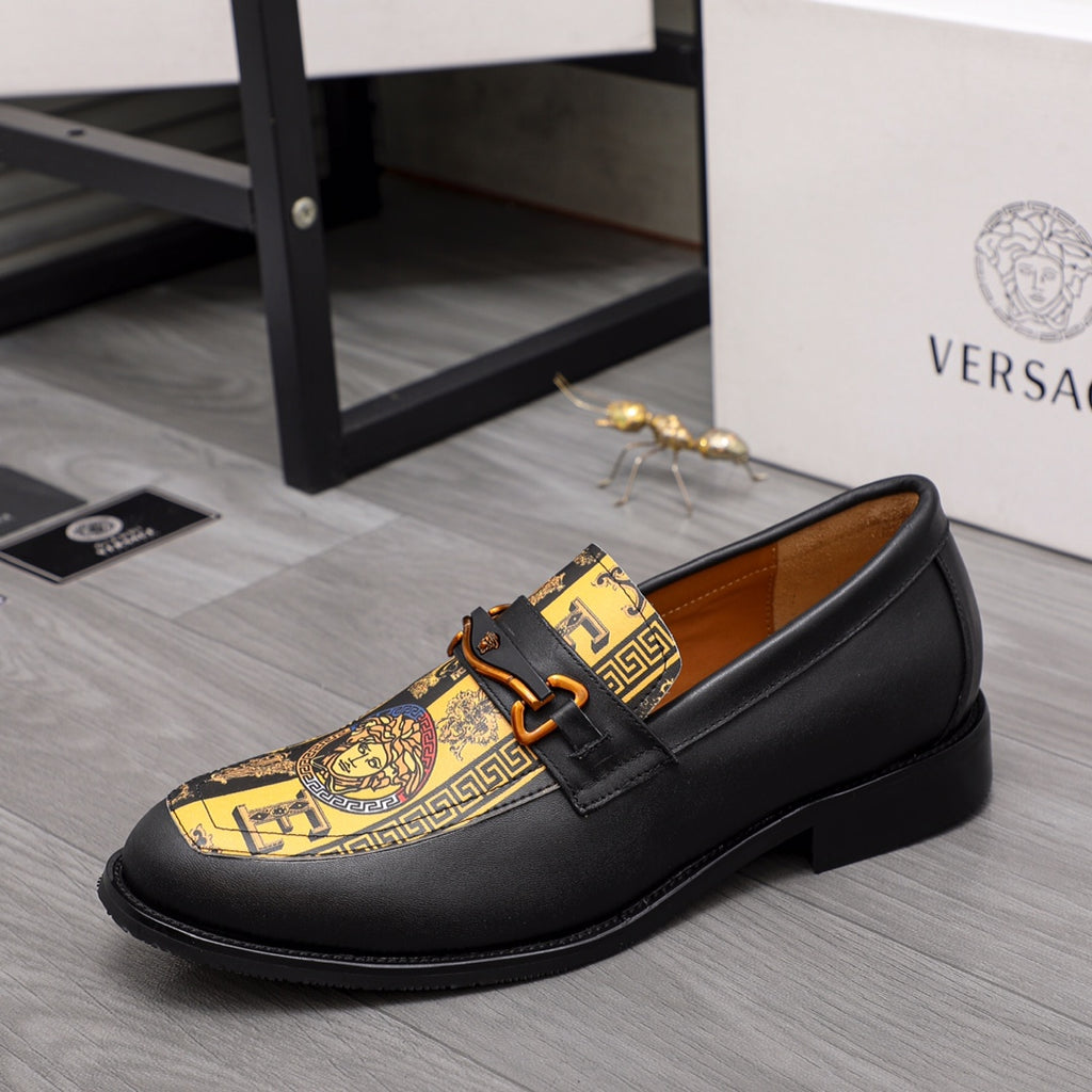Versace loafer shoe in black with gold patterned vamp and orange-brown buckle