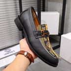 Versace loafer shoe with black leather and gold patterned stripe panel