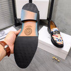 Versace black loafer outsole with textured tread pattern and small logo stamp