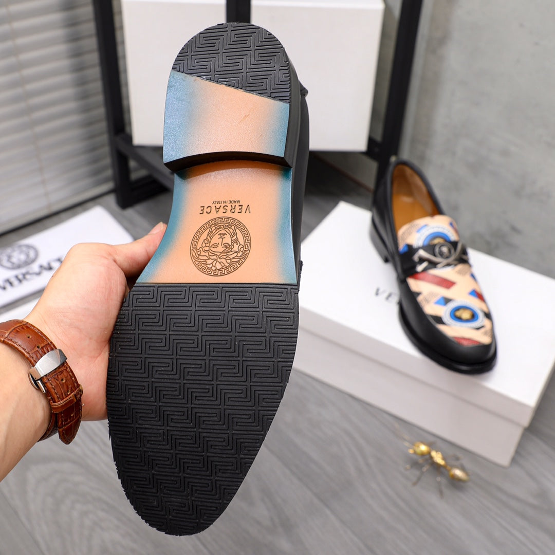 Versace black loafer outsole with textured tread pattern and small logo stamp