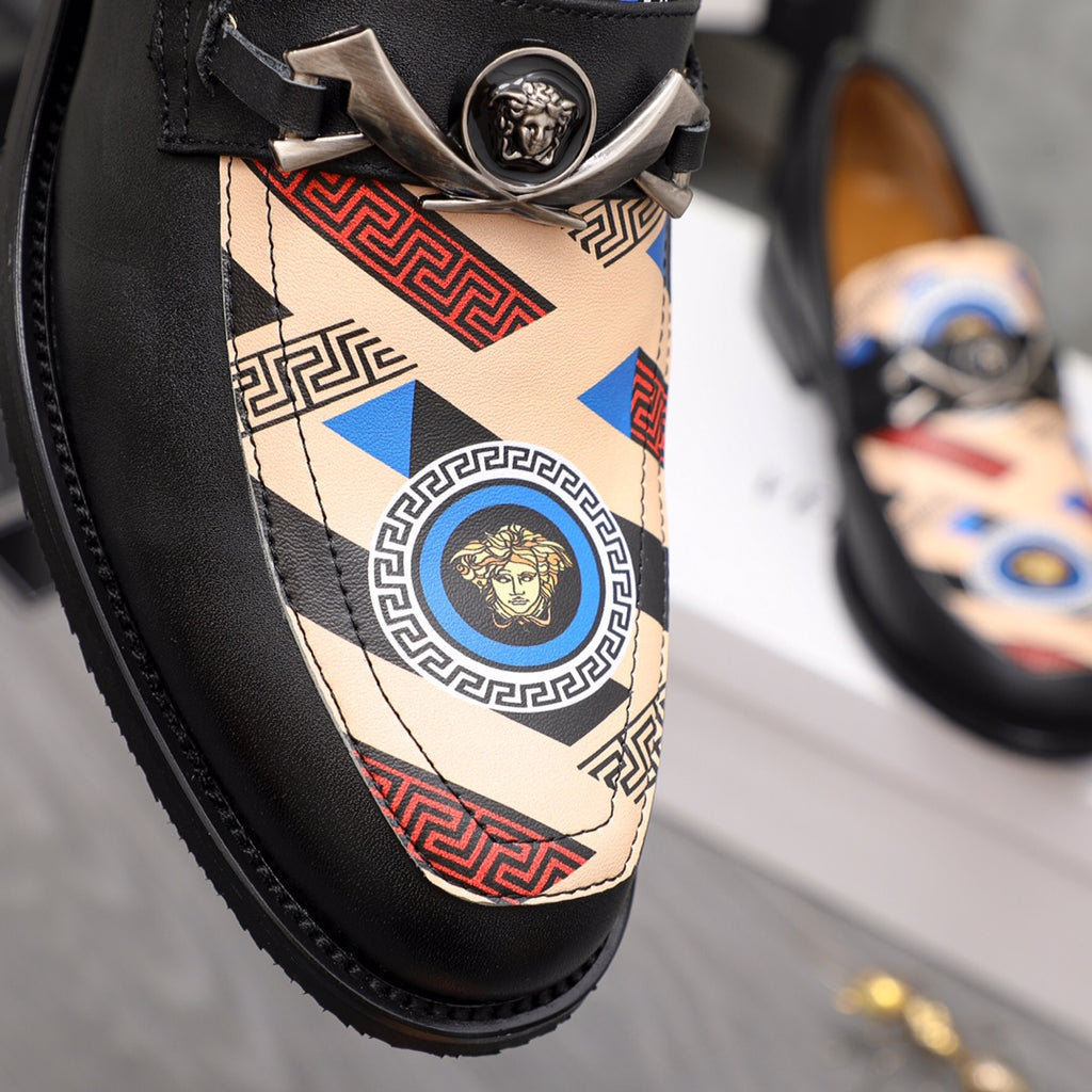 Versace loafer close-up: black leather with patterned fabric vamp and silver medallion
