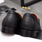 Versace black leather loafers heel view with smooth outsole and stitched seams