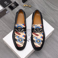 Versace black leather loafers with patterned upper panel and round medallion buckle