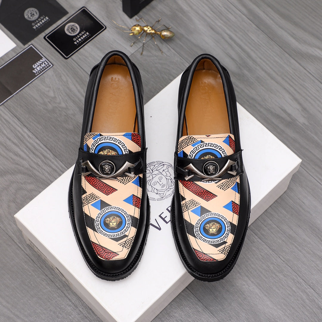 Versace black leather loafers with patterned upper panel and round medallion buckle