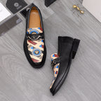 Versace black leather loafers pair with patterned side panels and strap buckle