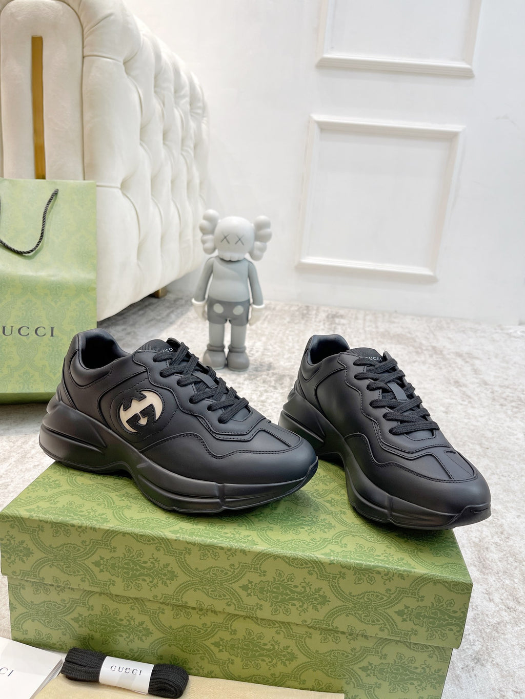Gucci unisex low-top sneakers pair in dark leather with lace-up on patterned box