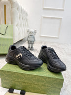Gucci unisex low-top sneakers pair in dark leather with lace-up on patterned box