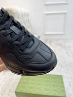 Gucci unisex sneaker close-up with dark leather laces, stitching, and logo detail