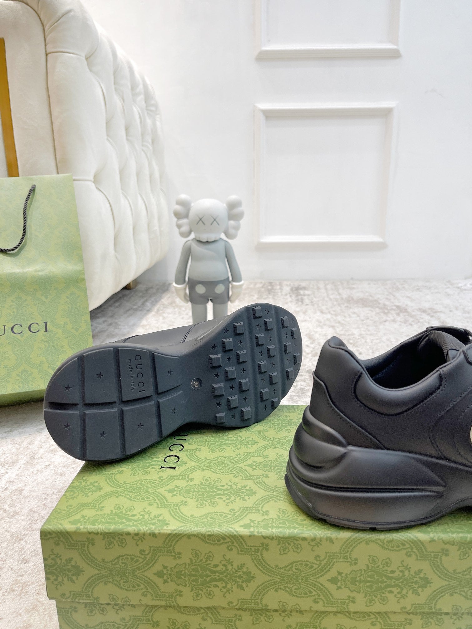 Gucci unisex sneaker outsole view with tread and dark leather heel and logo