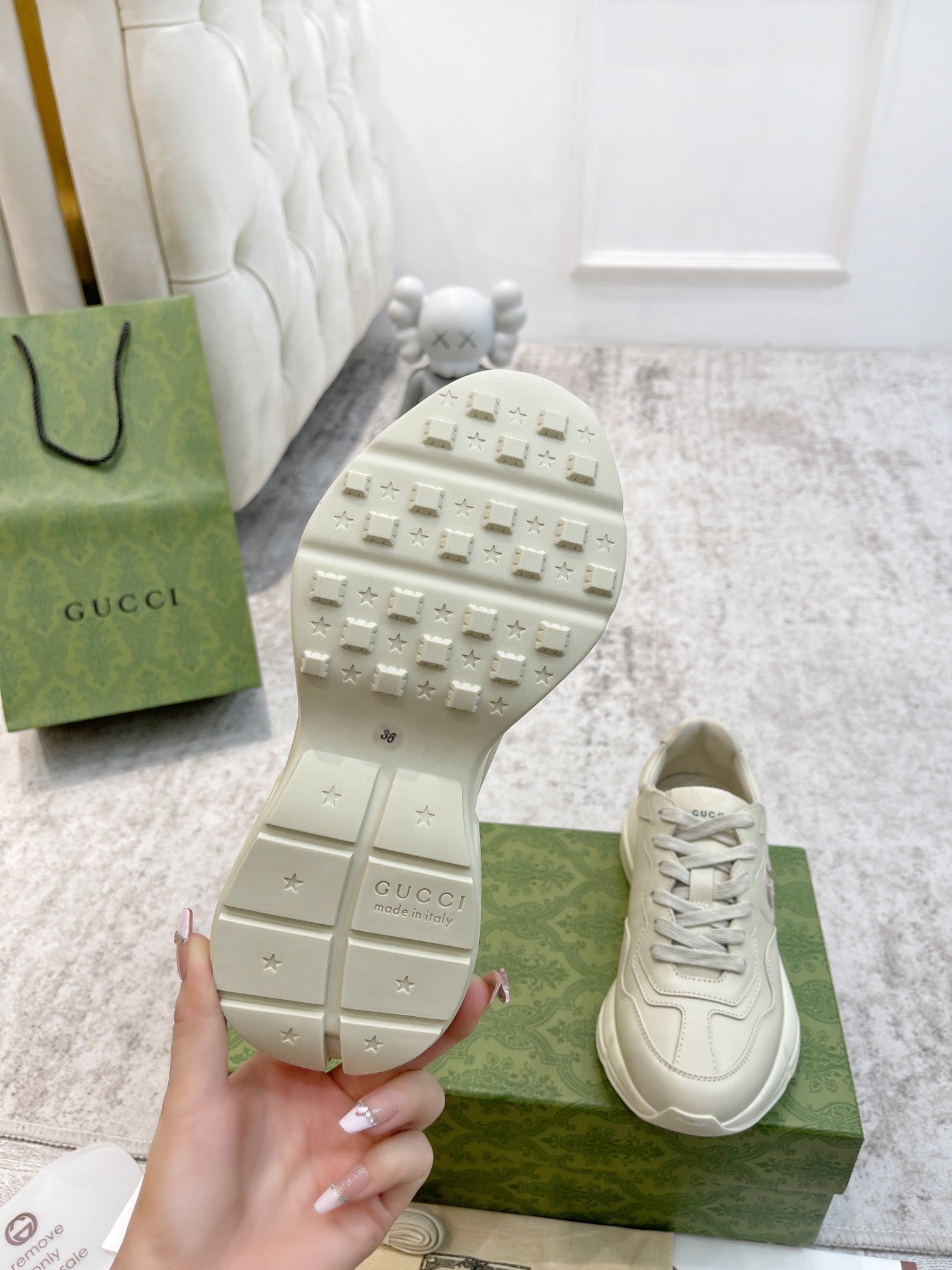 Gucci unisex sneaker outsole view, textured traction tread on cream sole