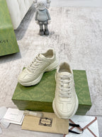 Gucci unisex cream sneakers pair on box, white laces and side logo emblem
