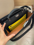 Fendi handbag open interior with yellow lining, zip pocket, and silver hardware