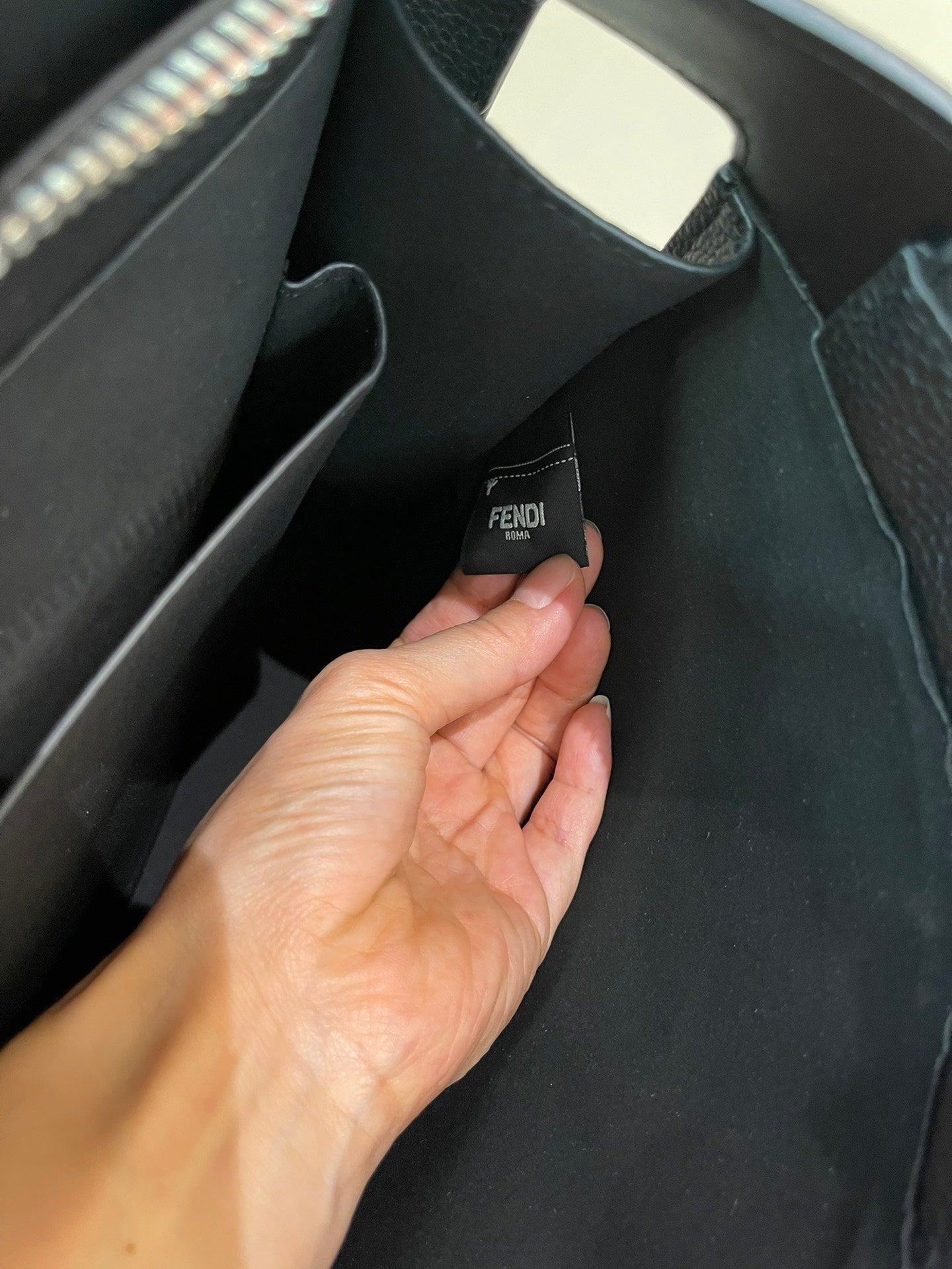 Fendi handbag interior showing a FENDI logo label on the lining