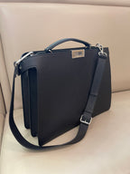 Fendi handbag front view with structured flap, top handle, and adjustable shoulder strap