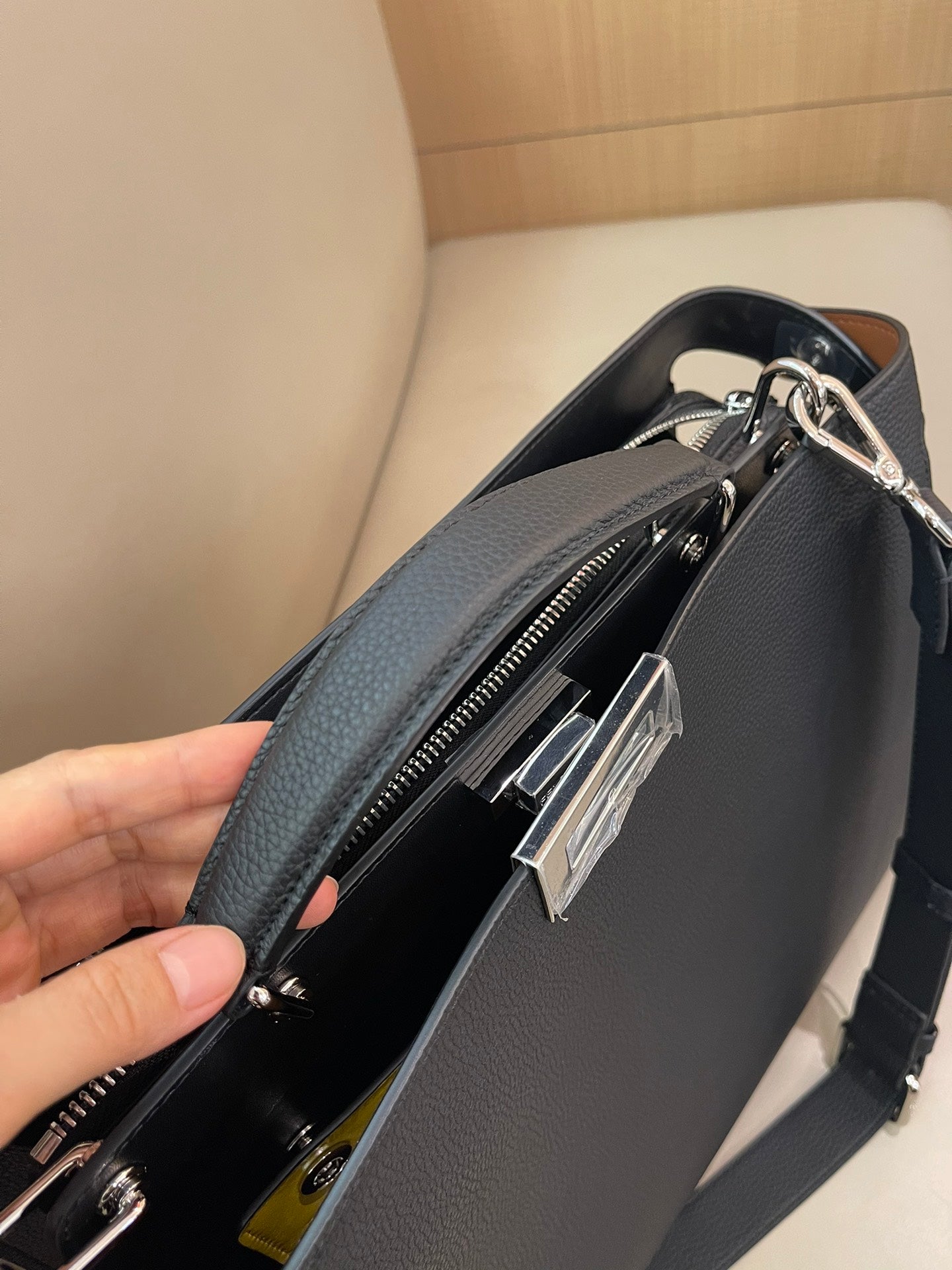 Fendi handbag close-up showing zipper opening and inner compartment with silver hardware