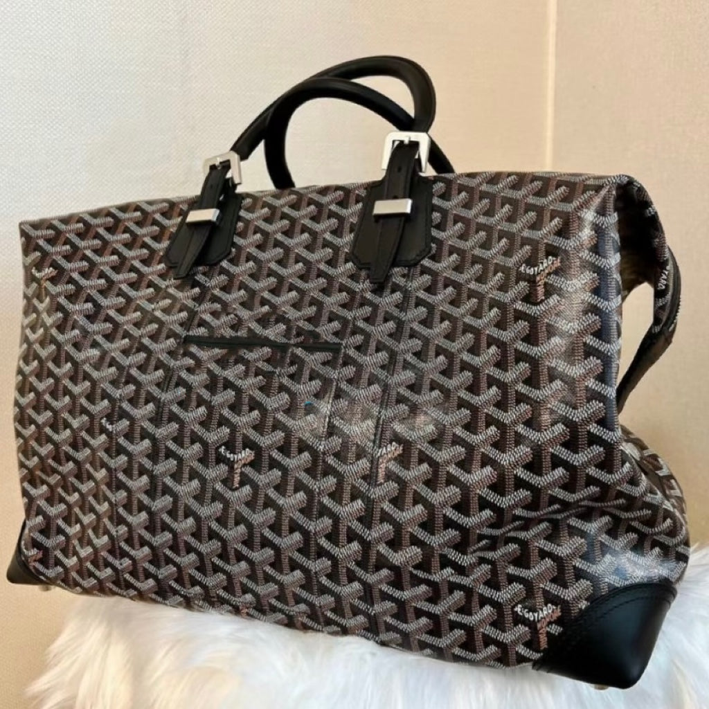 Tote bag with monochrome monogram pattern, top handles, and shoulder strap attachment.