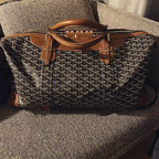 Goyard tote bag with structured top handles, zip closure, and patterned monogram fabric.