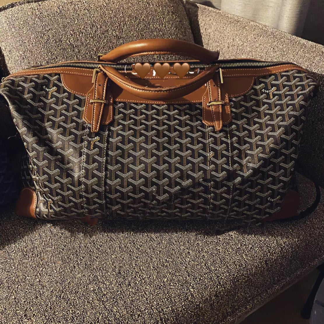 Goyard tote bag with structured top handles, zip closure, and patterned monogram fabric.