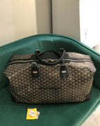 Tote bag with gray monogram pattern, black top handles, and adjustable shoulder strap.