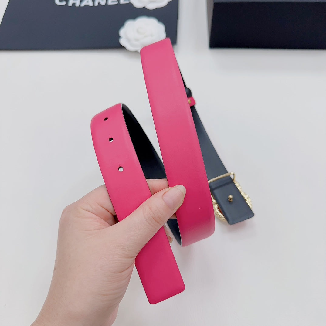 Pink leather belt strap with punched holes, shown with black underside