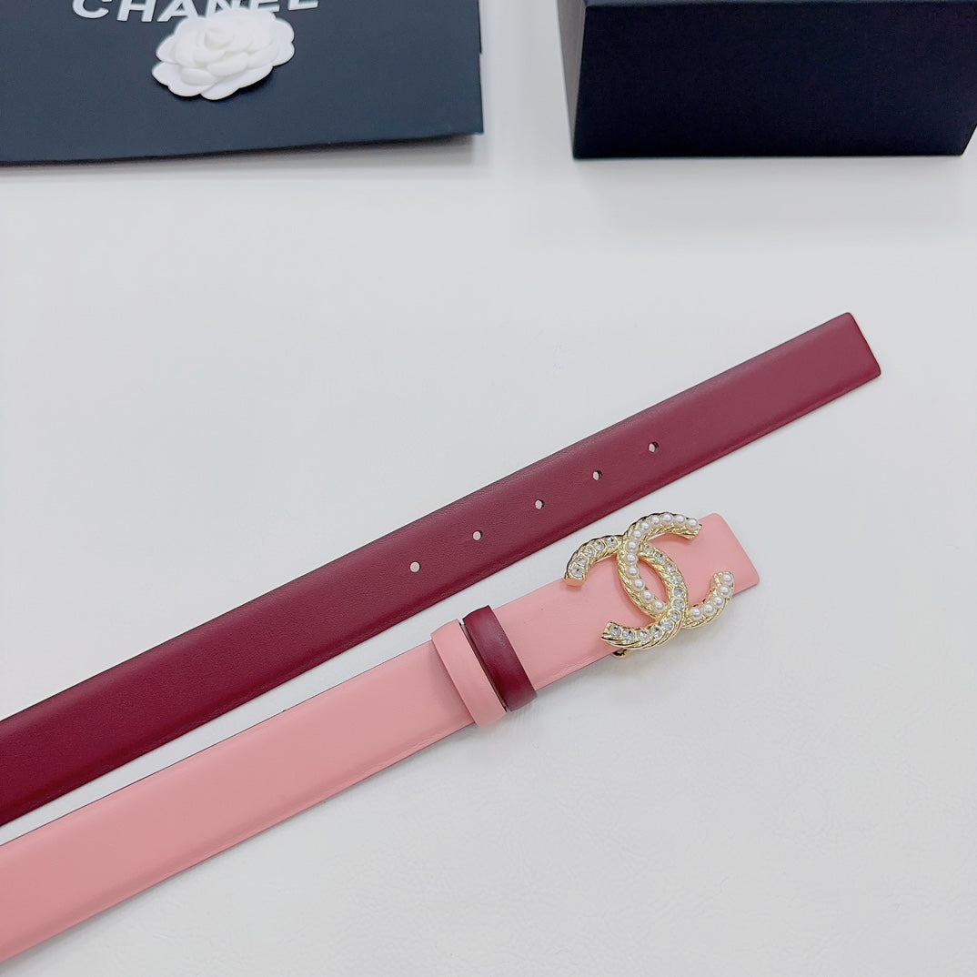 Pink Chanel belt showing punched holes and gold-tone CC buckle with jewel trim