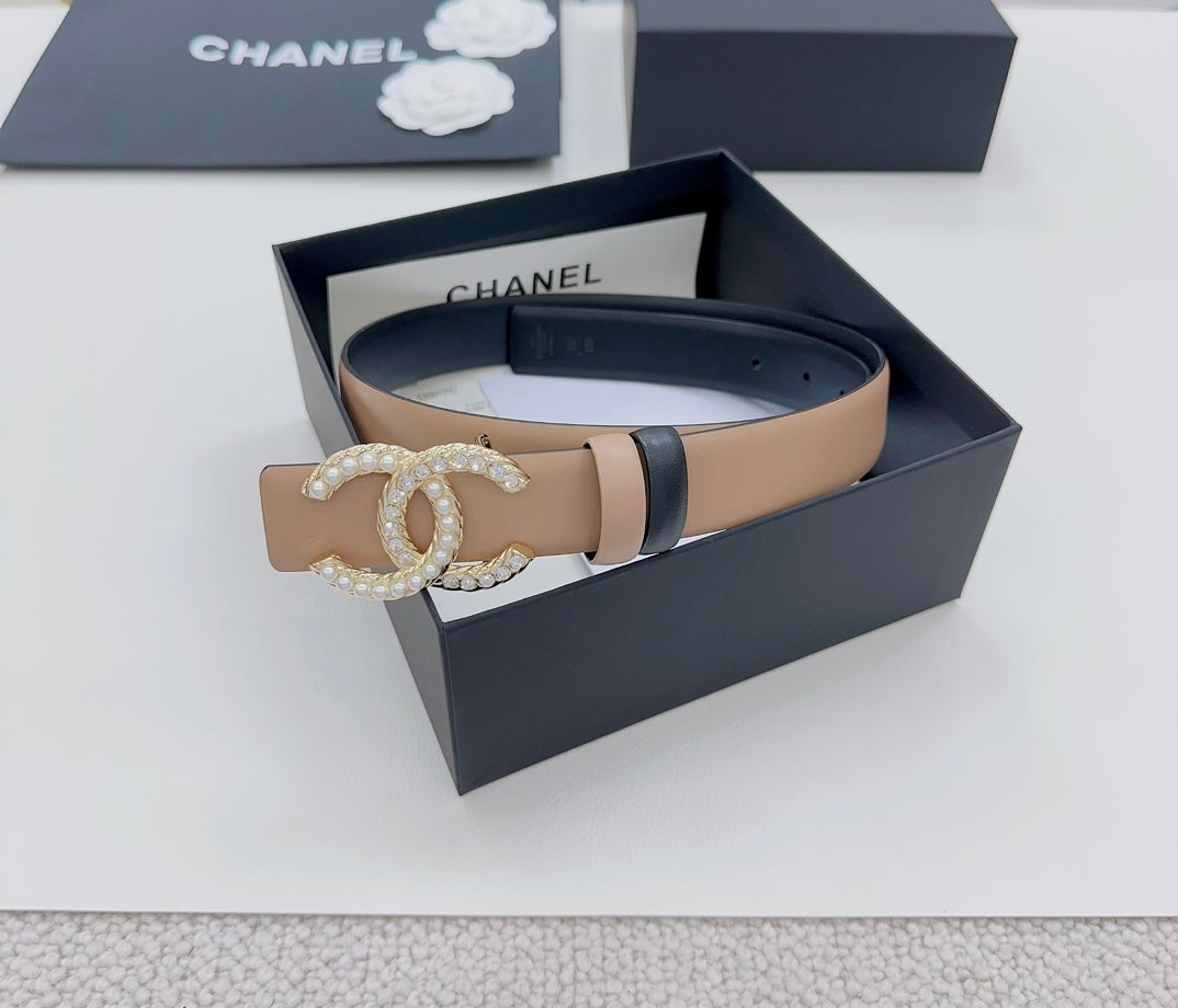 Tan leather belt with navy edges and gold-tone double-C crystal buckle