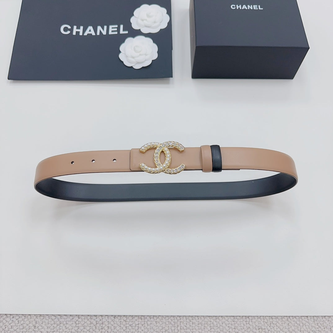 Tan leather belt with navy underside and gold-tone double-C crystal buckle