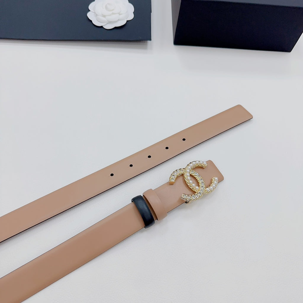 Tan belt strap with hole row and gold-tone double-C crystal buckle detail