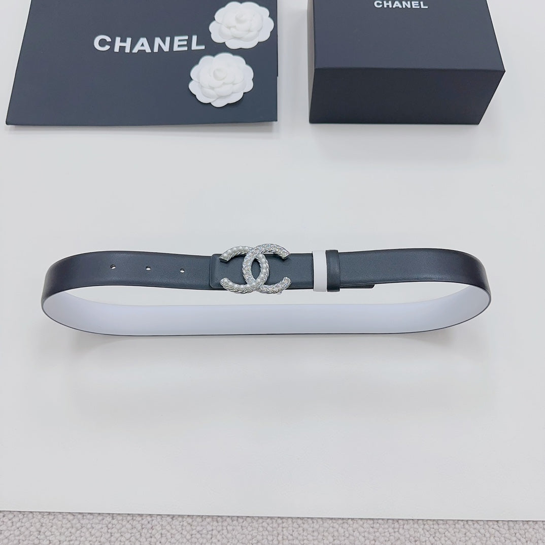 Dark leather belt laid flat with silver rhinestone CC buckle and metal keeper