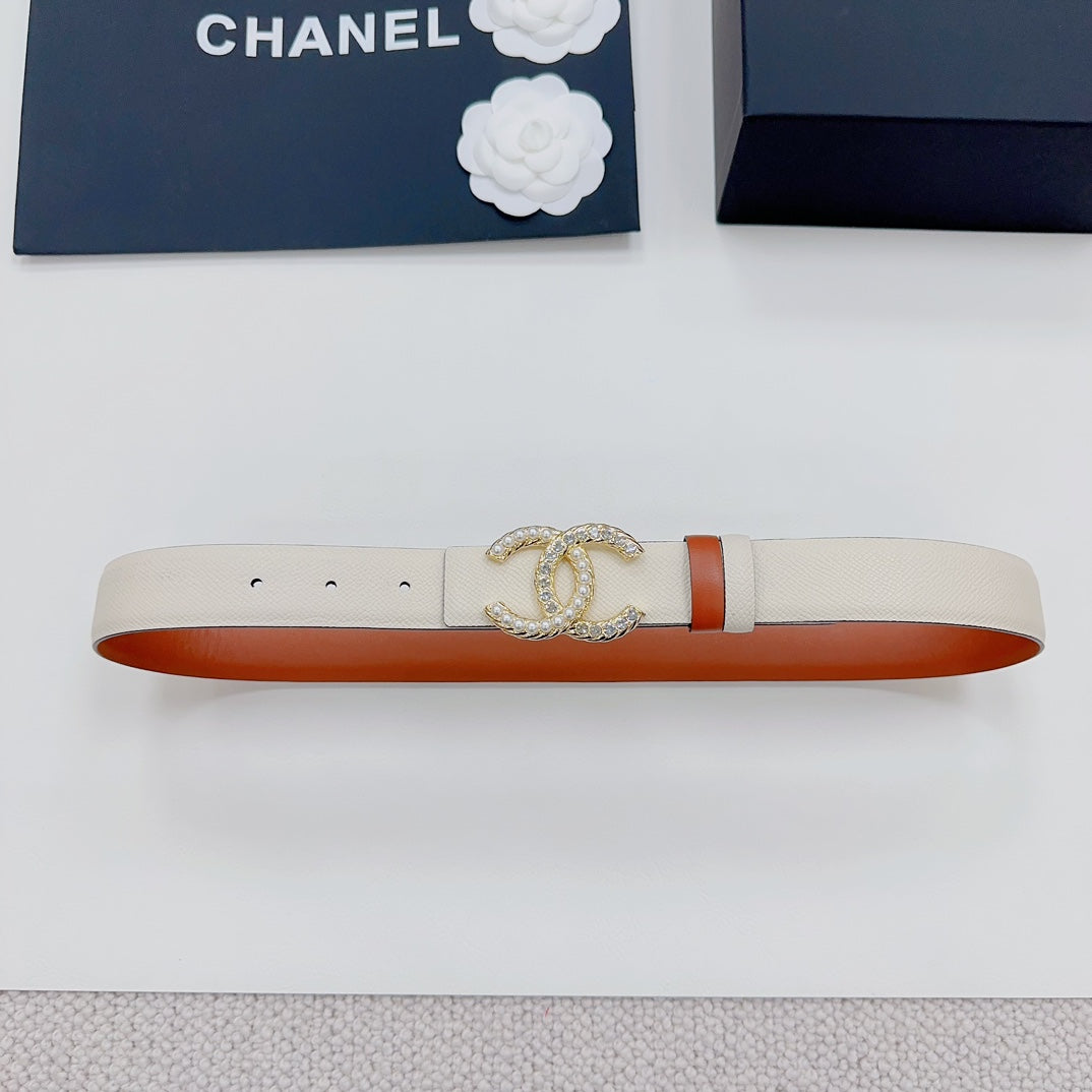 Chanel belt front view: beige strap with gold-tone CC buckle and orange border.