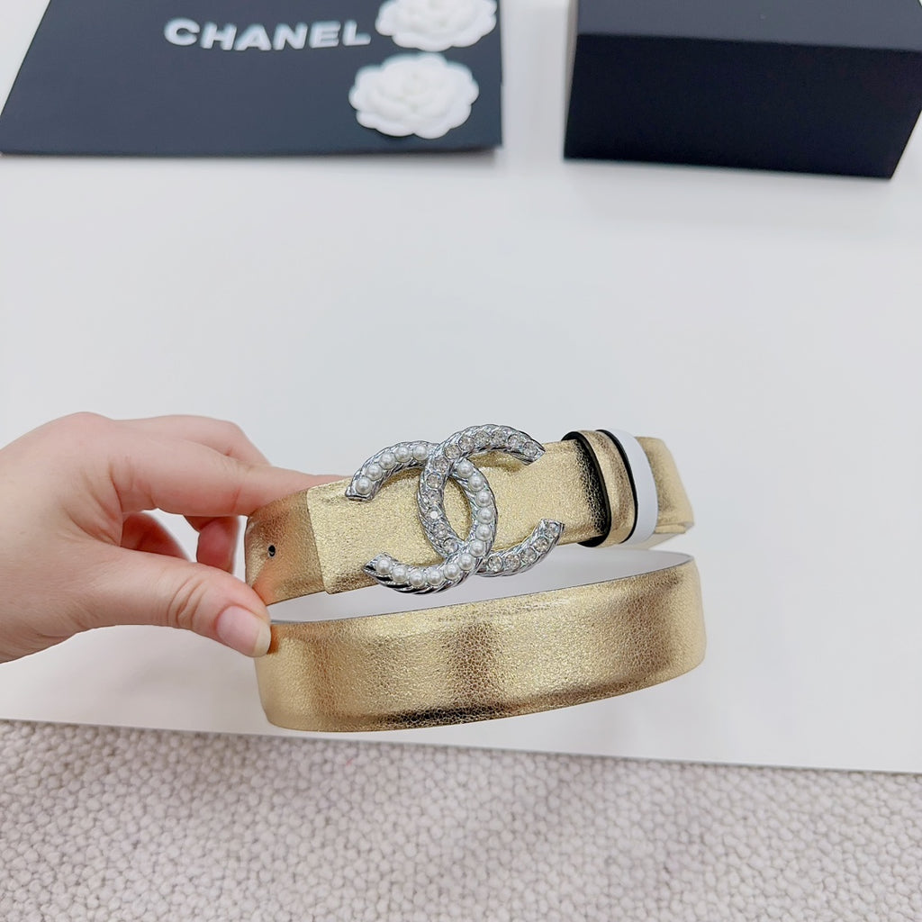 Gold-tone belt with silver CC rhinestone buckle and black stripe, side view