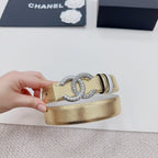 Gold-tone belt with silver CC rhinestone buckle and black stripe, side view