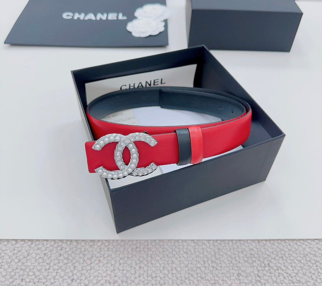 Chanel leather belt in red with silver-tone CC buckle and black keeper stripe.
