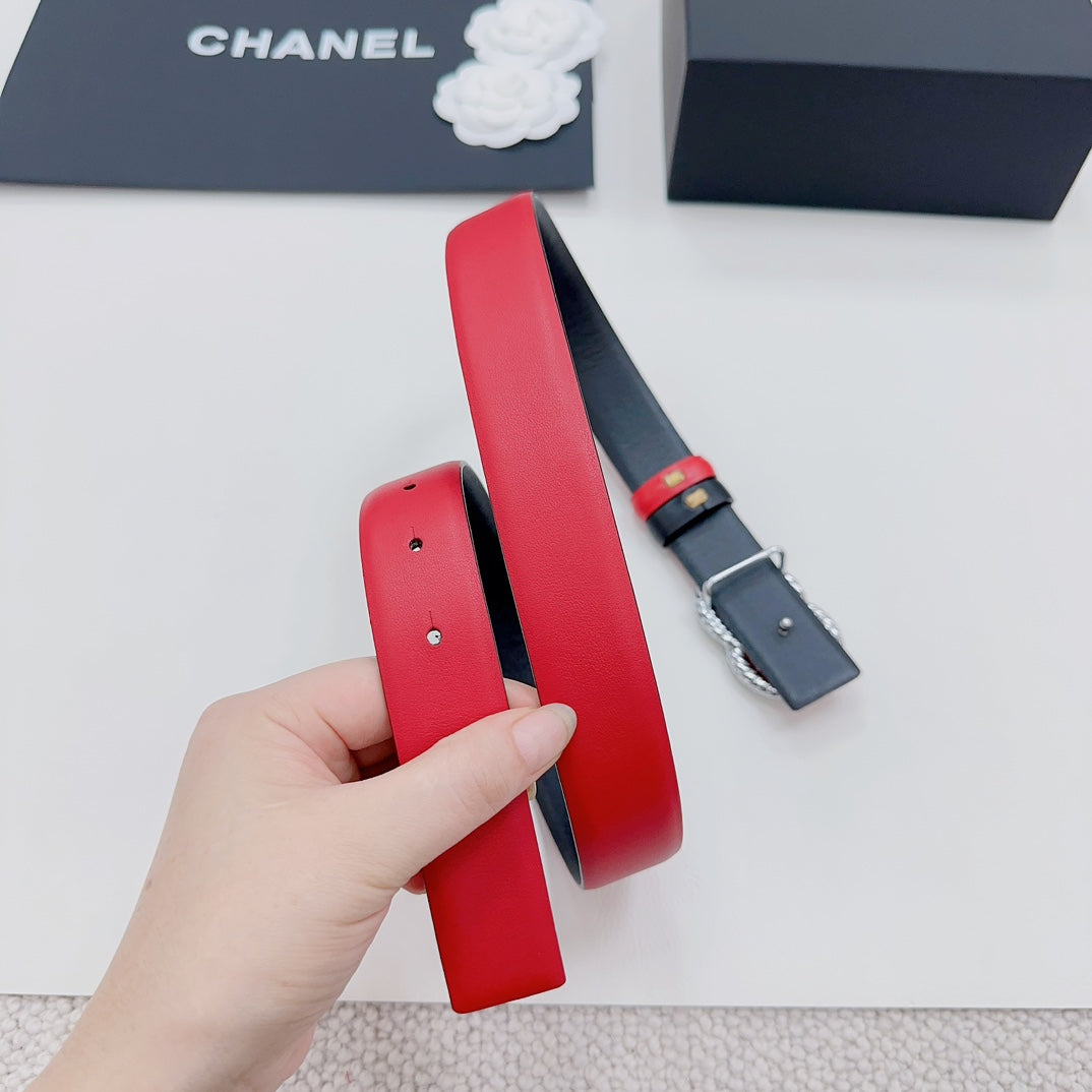 Chanel leather belt folded; red strap with dark backing and CC buckle.