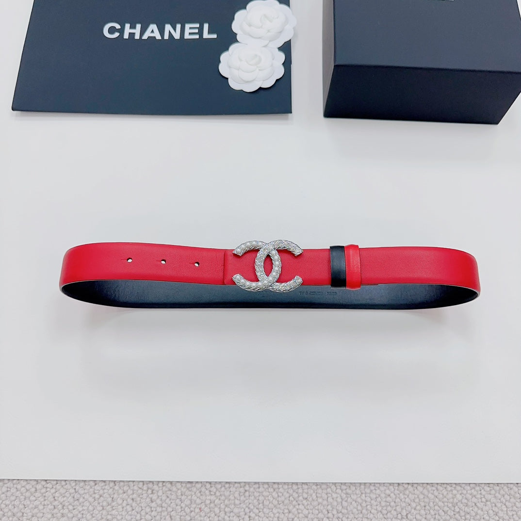 Chanel red leather belt with silver-tone CC buckle and black strap trim.