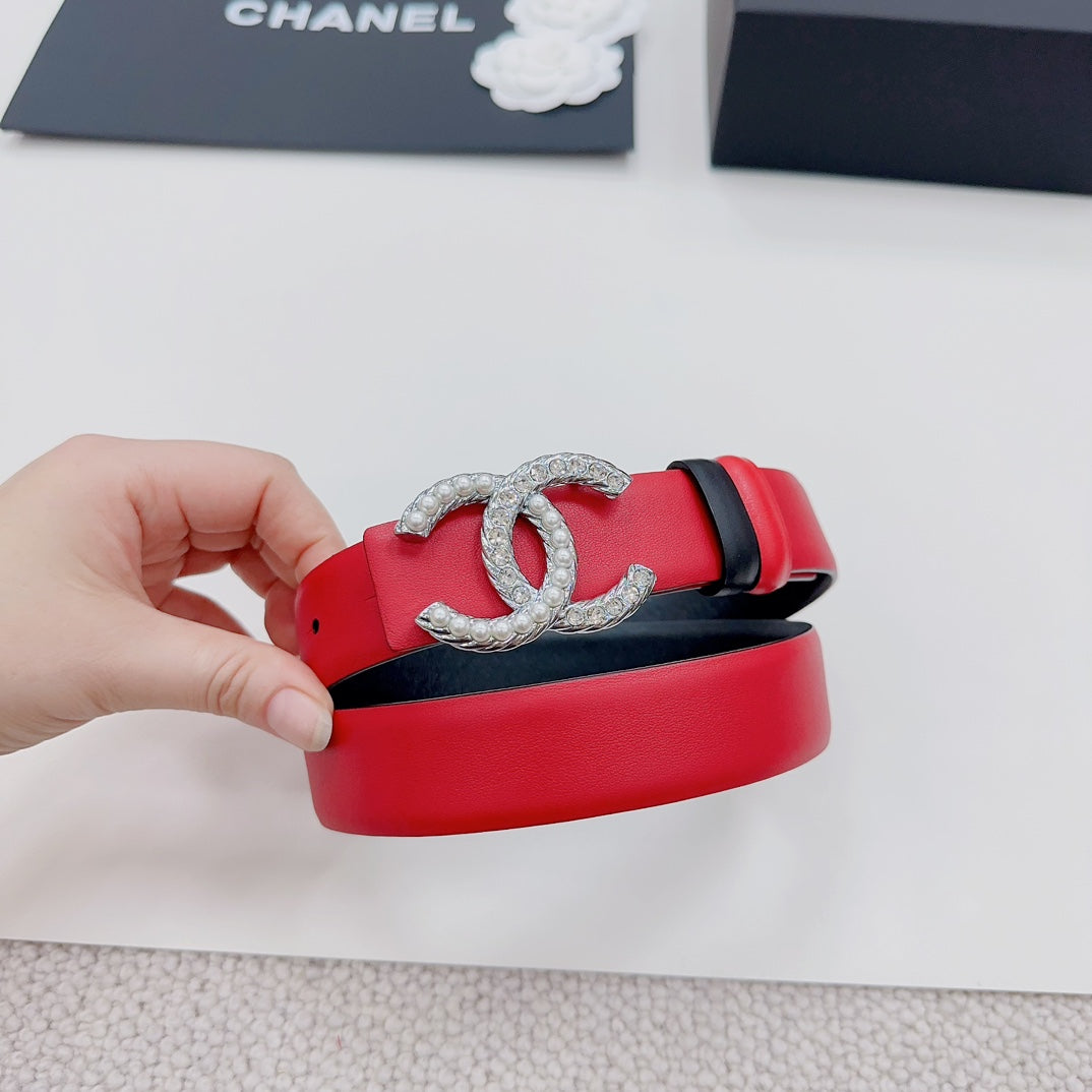 Chanel belt with red strap, silver-tone CC buckle, and black keeper detail.