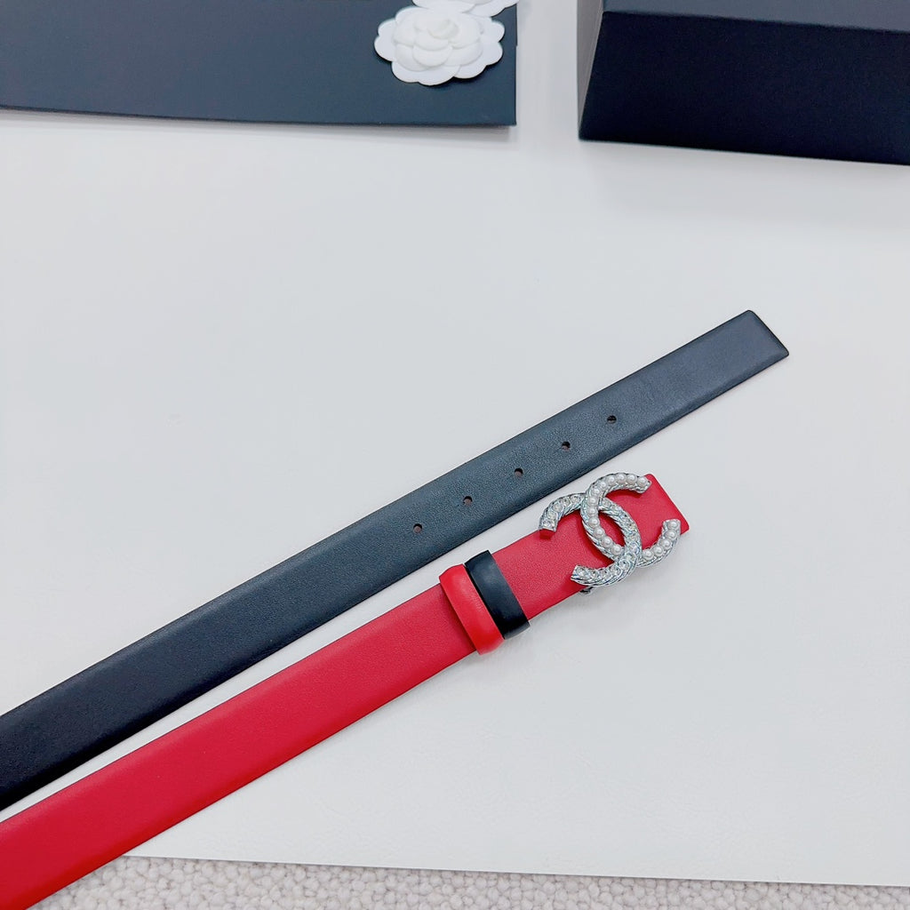 Chanel belt detail: red and dark strap with silver-tone CC buckle set.