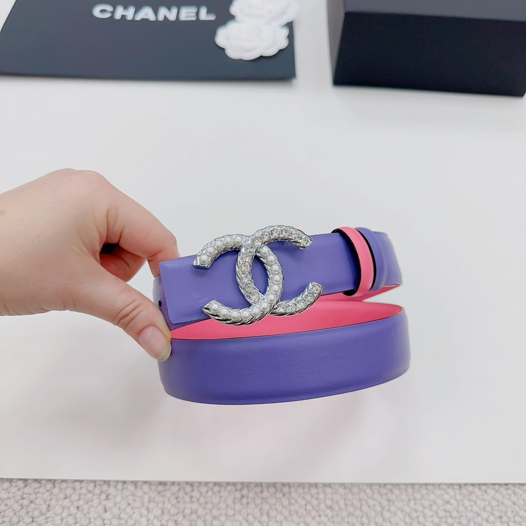 Chanel belt detail: purple strap with pink stripe and silver-tone CC buckle inlay