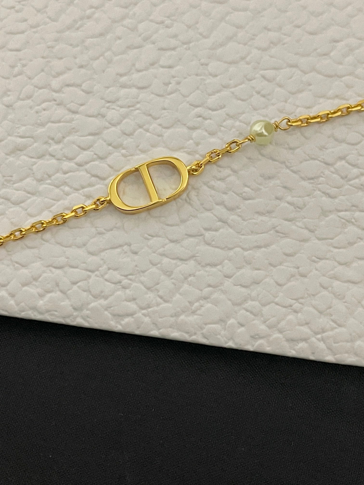 Gold-tone chain bracelet with oval Dior D medallion charm