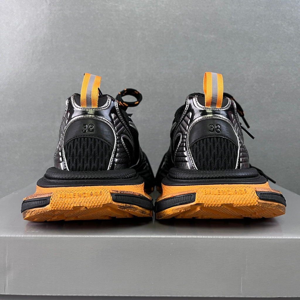 Balenciaga unisex chunky sneakers, back view with orange heel pull tabs and tread