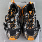 Balenciaga unisex chunky sneakers, pair front view with orange laces and logo accents